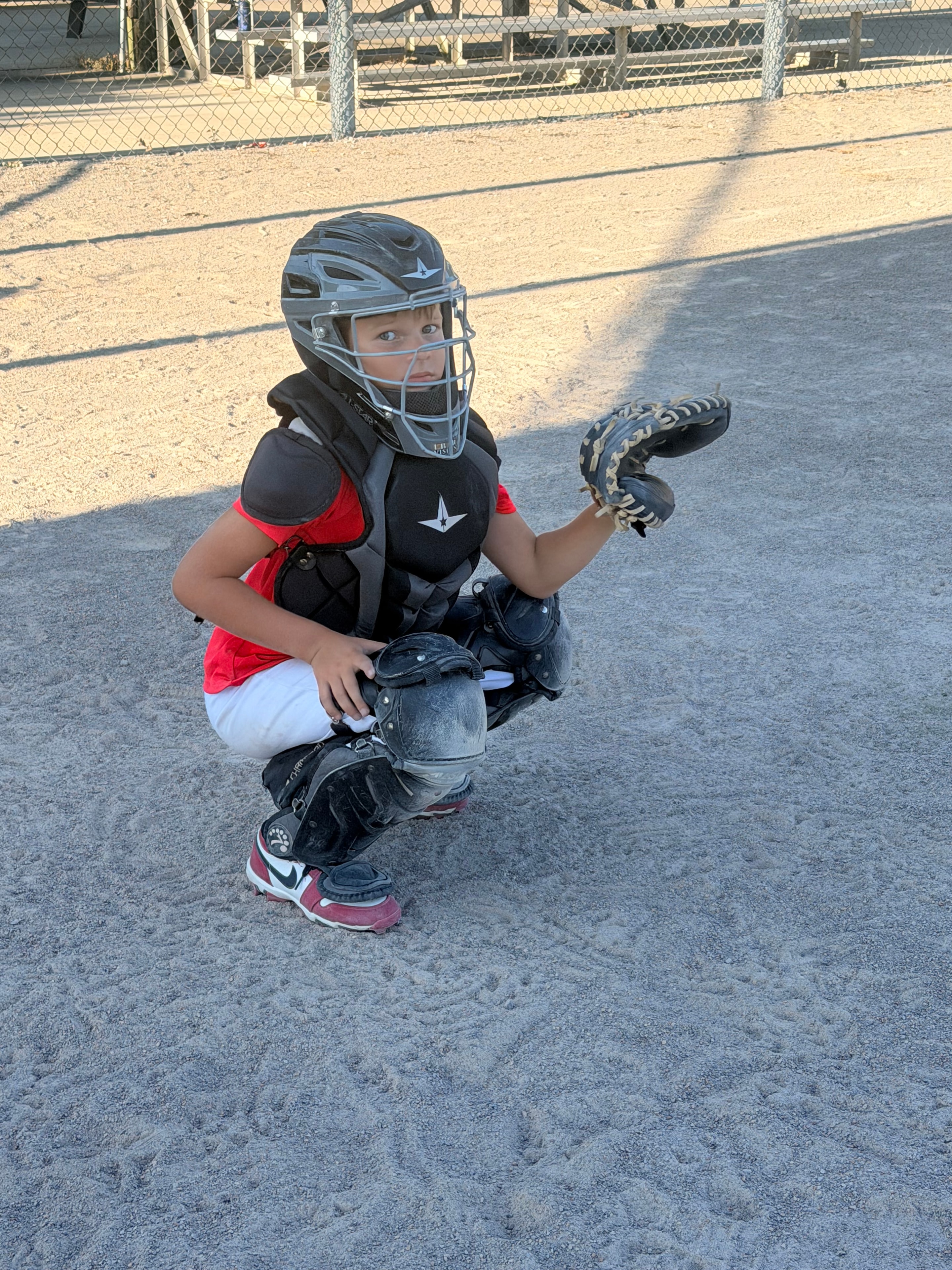 Young catcher working a fielding drill