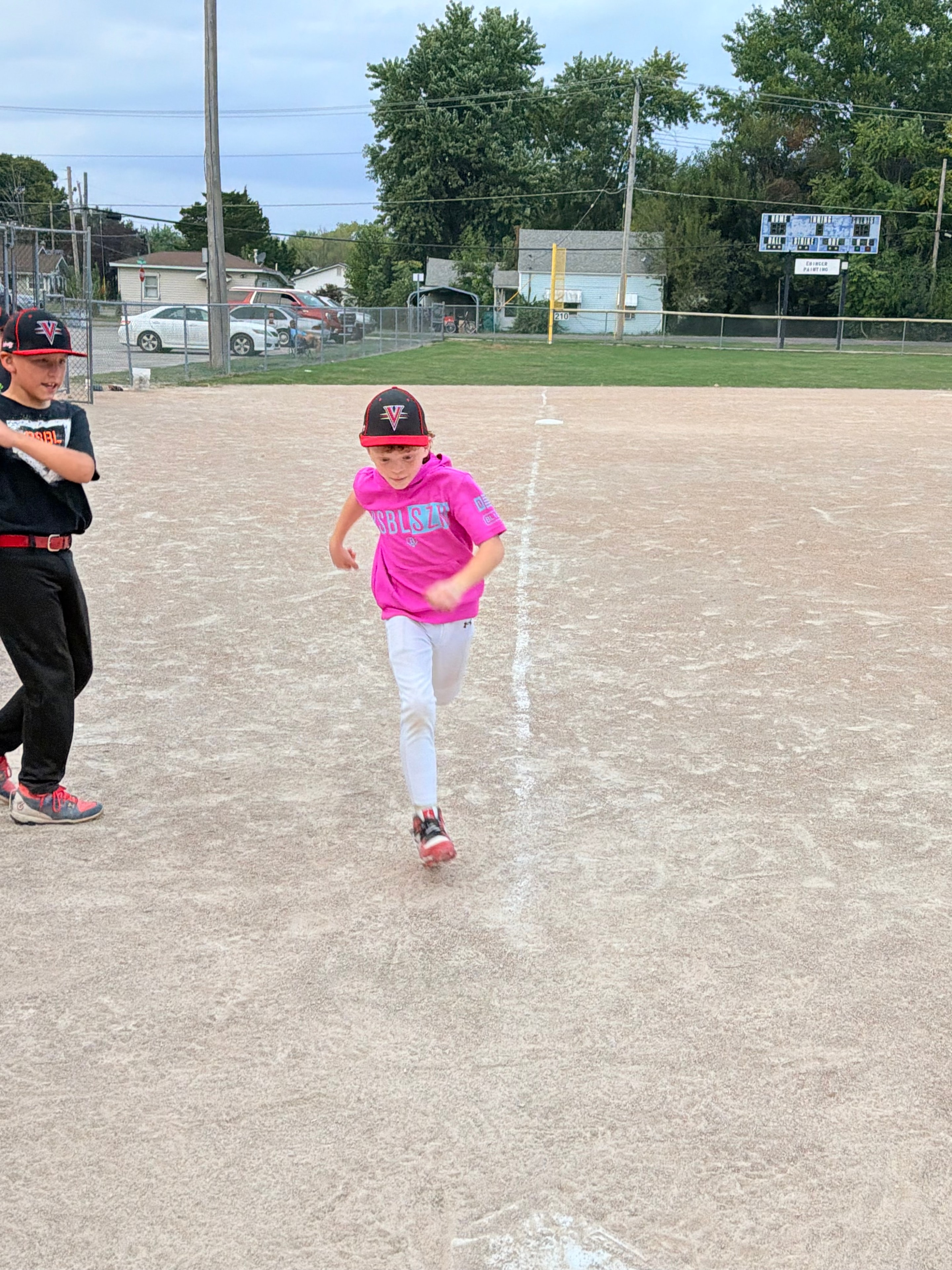 Velocity player in pink jersey pitching on the field