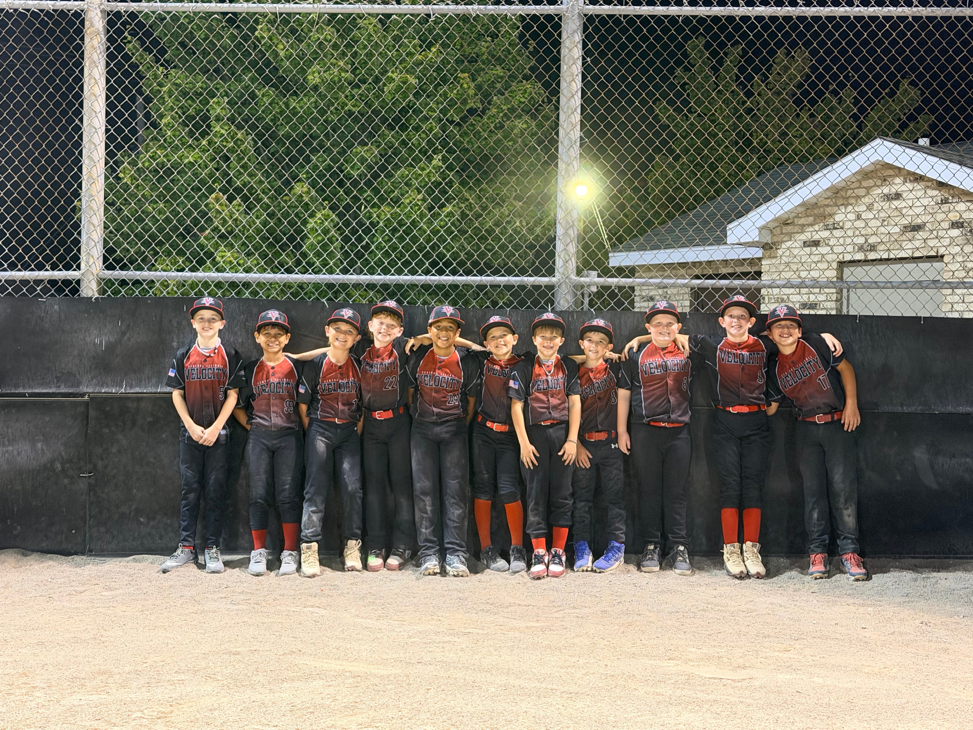 Velocity 10U team lined up in the dugout